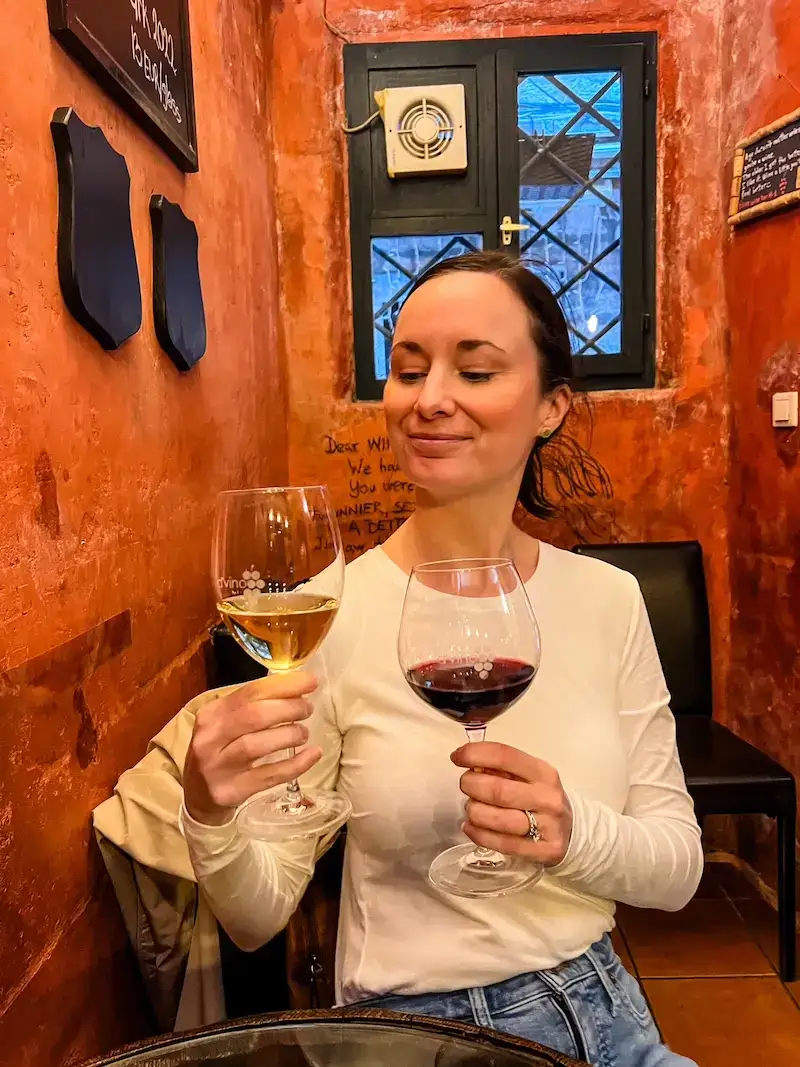 A woman poses with her wine after one day in Dubrovnik.