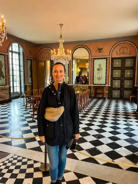 A woman poses inside the Château de Malmaison on a day trip from Paris.