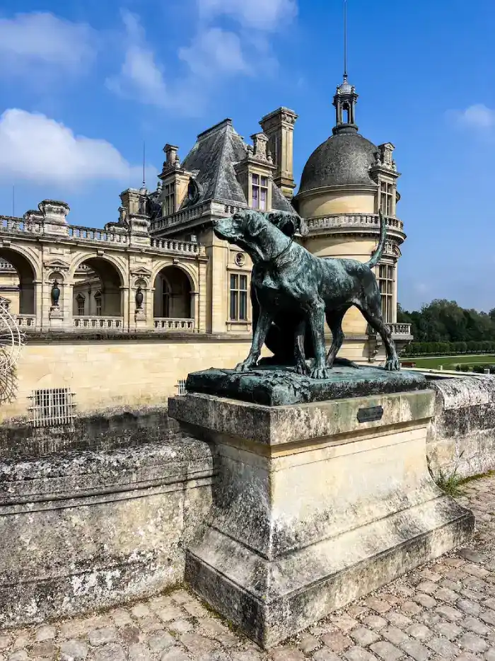 A statue outside the castle in Chantilly on a Paris day trip